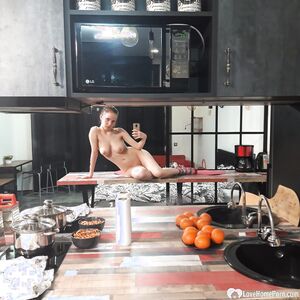 Horny babe posing on the kitchen counters