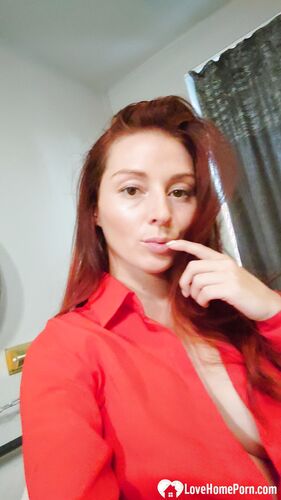 Naughty redhead reveals her big tits on cam