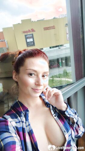 Naughty redhead reveals her big tits on cam