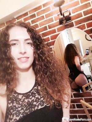 Cutie with curly brunette hair shows her tits