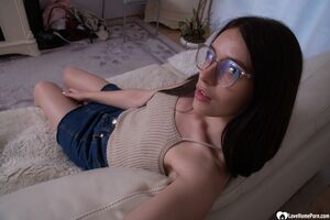 Cute long-haired brunette takes selfies in the bathroom