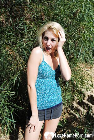 Blonde with tattoos does a striptease outside