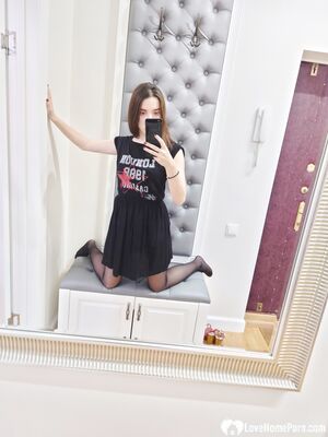 Cutie shows her stockings while posing passionately