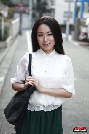 Petite Japanese porn starlet Anna Sakura posing in her green skirt