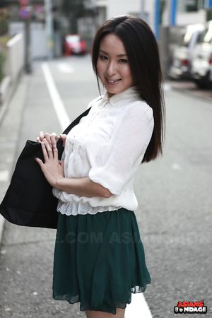 Petite Japanese porn starlet Anna Sakura posing in her green skirt