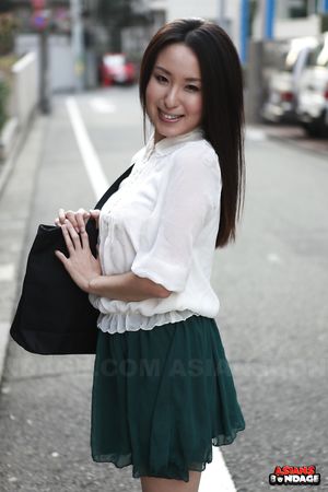 Petite Japanese porn starlet Anna Sakura posing in her green skirt