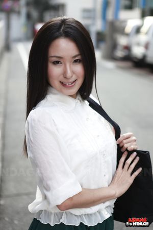 Petite Japanese porn starlet Anna Sakura posing in her green skirt