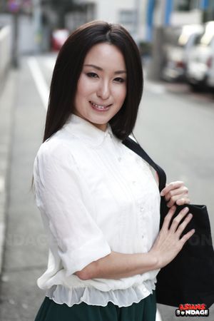 Petite Japanese porn starlet Anna Sakura posing in her green skirt