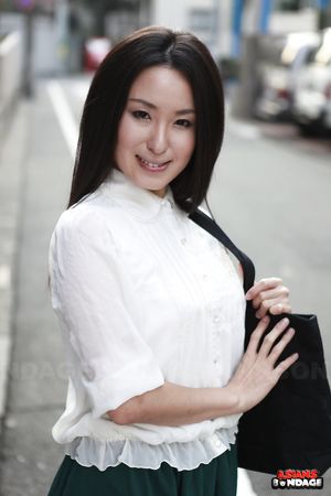 Petite Japanese porn starlet Anna Sakura posing in her green skirt