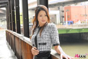 Risa poses in elegant office suit with a short skirt and high heels.