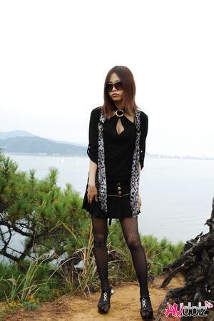 Naughty Rena shows her nude body in nature, at the ocean's shore.