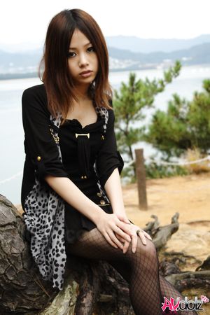 Naughty Rena shows her nude body in nature, at the ocean's shore.