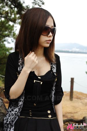 Naughty Rena shows her nude body in nature, at the ocean's shore.