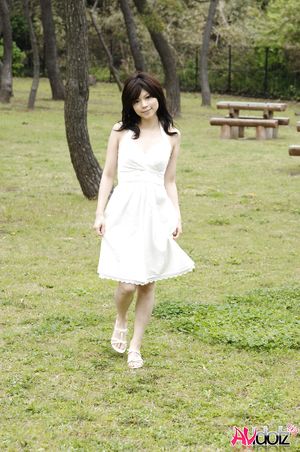 Asian Kurumi Katase in white dress is playful and happy in the nature.