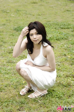 Asian Kurumi Katase in white dress is playful and happy in the nature.