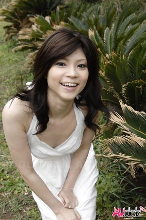 Asian Kurumi Katase in white dress is playful and happy in the nature.