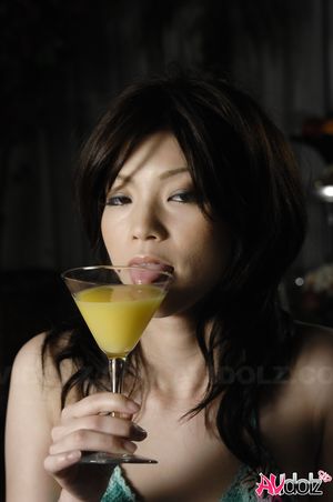 Kurumi Katase shows hot butt in green bikini and enjoys a drink.