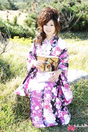 Asian Chiaki in kimono is romantic and beautiful at the ocean's shore.