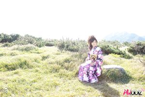 Asian Chiaki in kimono is romantic and beautiful at the ocean's shore.