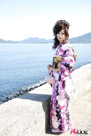 Asian Chiaki in kimono is romantic and beautiful at the ocean's shore.