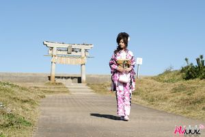 Asian Chiaki in kimono is romantic and beautiful at the ocean's shore.