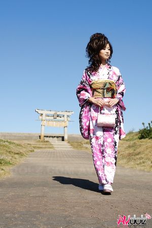Asian Chiaki in kimono is romantic and beautiful at the ocean's shore.