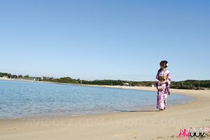 Asian Chiaki in kimono is romantic and beautiful at the ocean's shore.