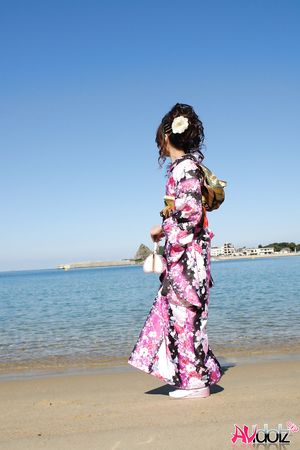 Asian Chiaki in kimono is romantic and beautiful at the ocean's shore.