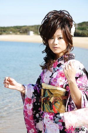 Asian Chiaki in kimono is romantic and beautiful at the ocean's shore.
