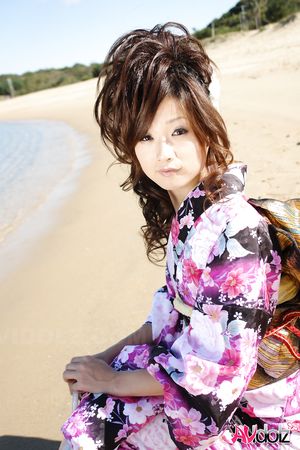 Asian Chiaki in kimono is romantic and beautiful at the ocean's shore.
