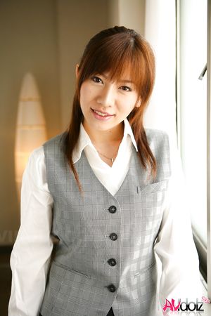 Asian Aki Yatou in uniform smiles a lot during this photo session.