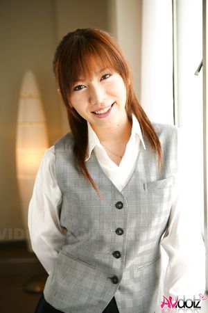 Asian Aki Yatou in uniform smiles a lot during this photo session.