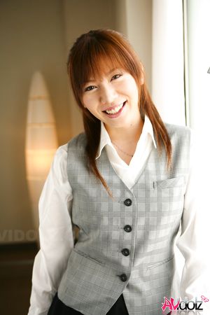 Asian Aki Yatou in uniform smiles a lot during this photo session.