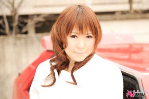 Asian Yuko Morita in white coat and long boots poses in her car.