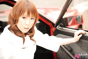 Asian Yuko Morita in white coat and long boots poses in her car.