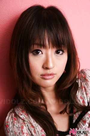 Hot Saori licks her lips erotically when posing in a beautiful outfit.