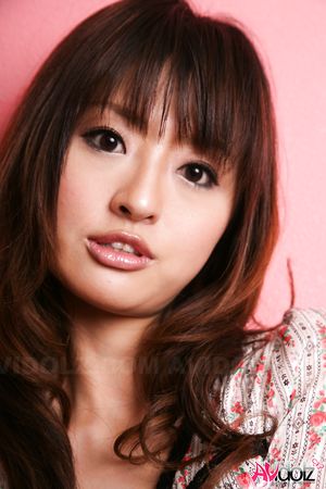 Hot Saori licks her lips erotically when posing in a beautiful outfit.