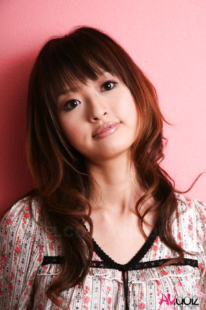 Hot Saori licks her lips erotically when posing in a beautiful outfit.