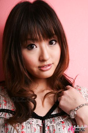 Hot Saori licks her lips erotically when posing in a beautiful outfit.