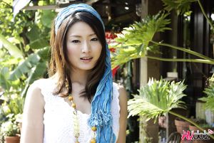 Risa in a white long dress shows legs while taking a bath in the sea.