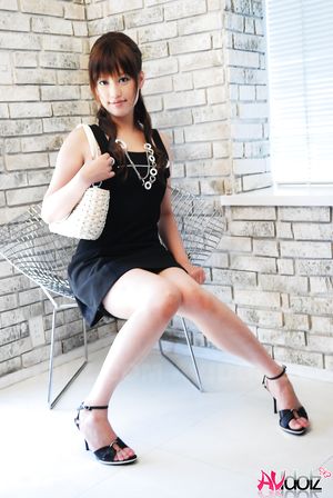 Asian Rika Nagasawa shows sexy legs while posing in a black dress.