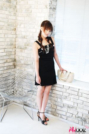 Asian Rika Nagasawa shows sexy legs while posing in a black dress.