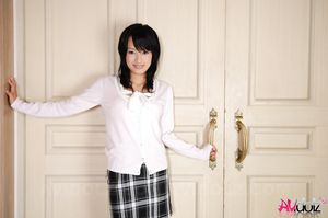 Asian Mio Kanna shows sexy legs in short skirt while posing on chair.