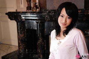 Asian Mio Kanna shows sexy legs in short skirt while posing on chair.