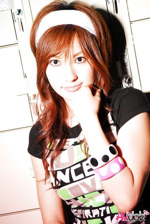 Asian Mecumi smiles all the time posing in short skirt and T-shirt.