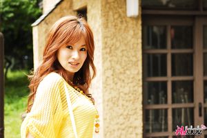 Mecumi in yellow blouse and shorts has a pleasant walk in the city.