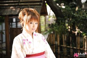 Asian Ichika in a beautiful kimono makes some soap bubbles outdoor.