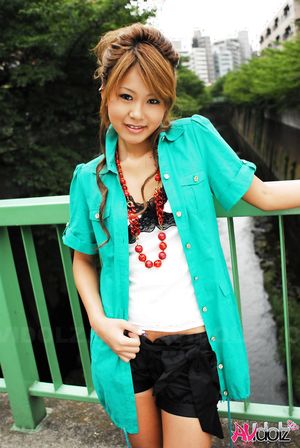 Asian Hitomi Mano poses outdoor and in her house in different outfits.
