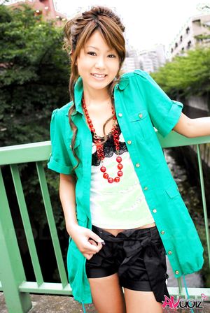 Asian Hitomi Mano poses outdoor and in her house in different outfits.