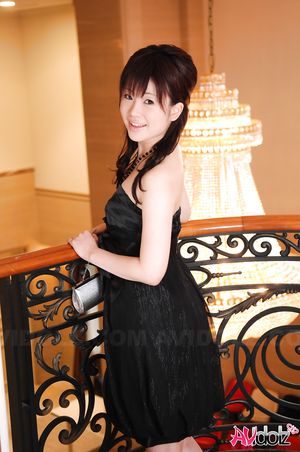 Beautiful Hina Kawamura in black dress enjoys a glass of champagne.